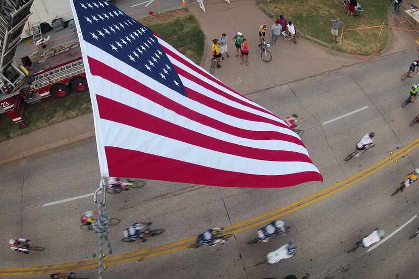  A large U.S. flag suspended between two Wichita Falls, Texas Fire Department aerial ladder...