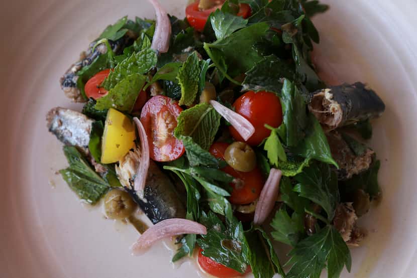 The sardine salad includes tomatoes, parsley, mint, and capers.