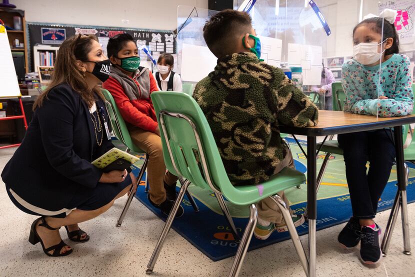 Susana Cordova, DISD deputy superintendent, speaks with second grader Jonathan Salazar...