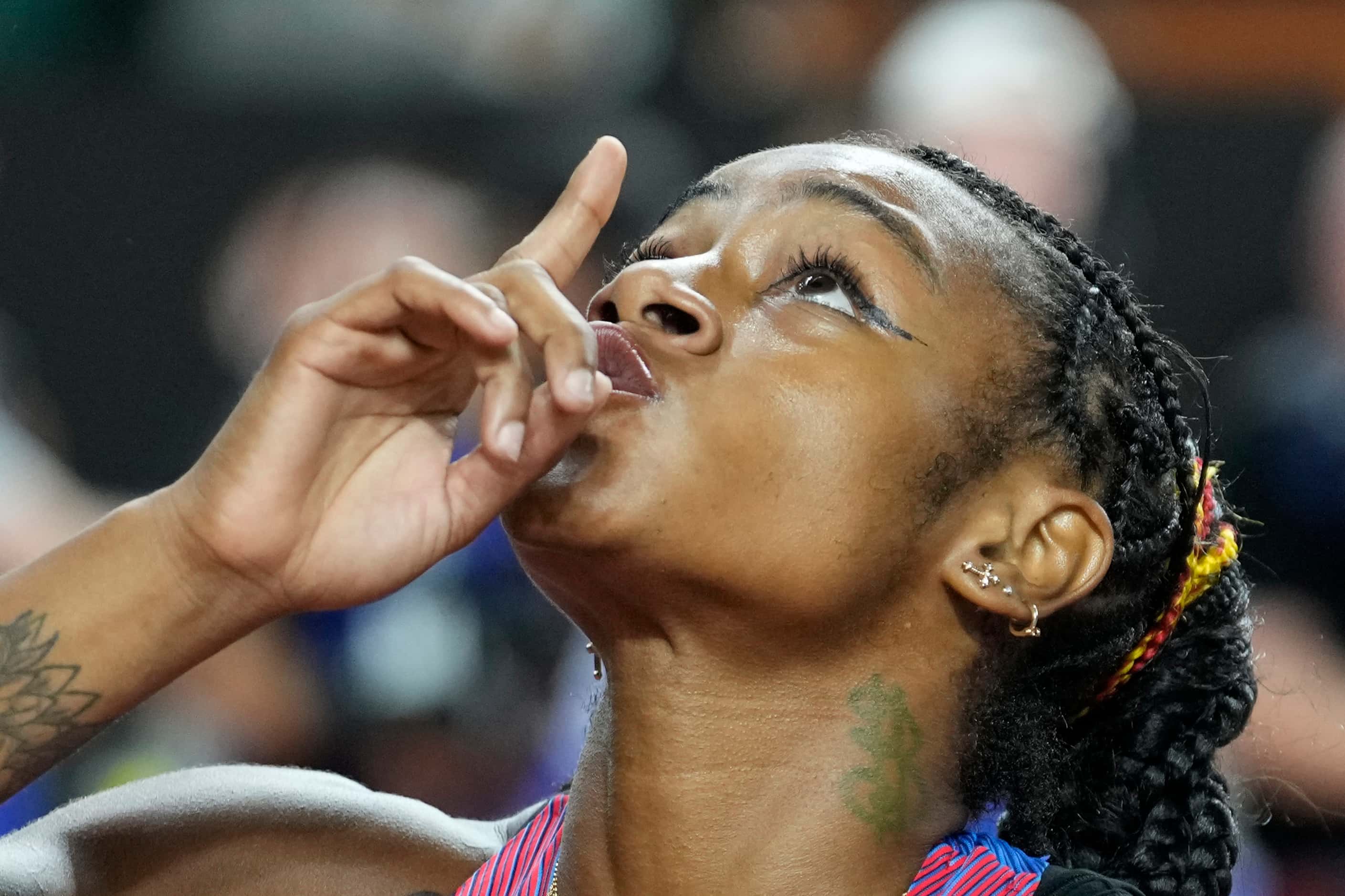 Sha'Carri Richardson, of the United States, reacts after crossing the finish line to win the...