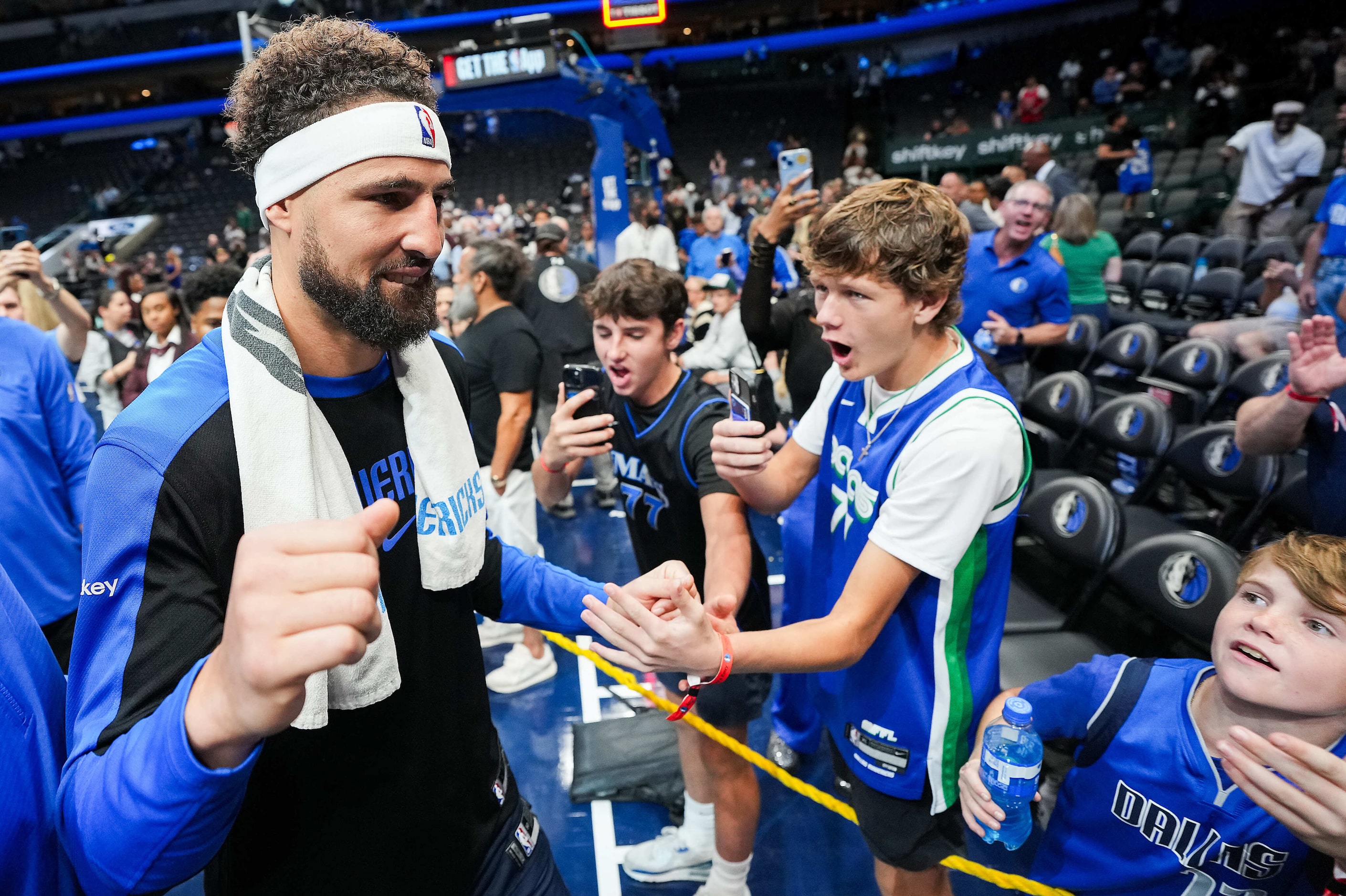 Dallas Mavericks guard Klay Thompson celebrates with fans as he leaves the court after the...