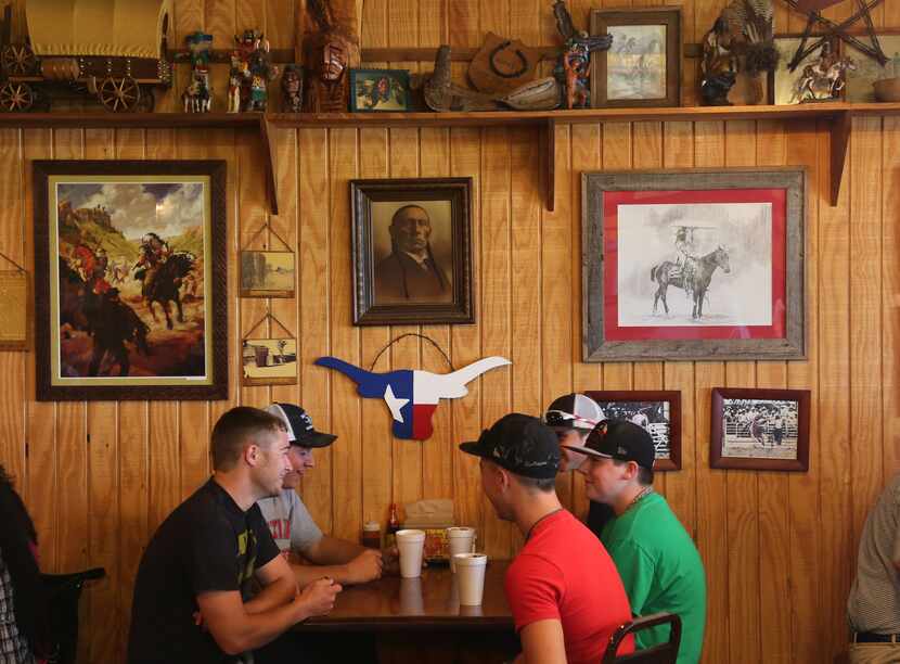Diners eat at Kirby's Barbeque in Mexia. Some of the photos depict the life of Comanche...