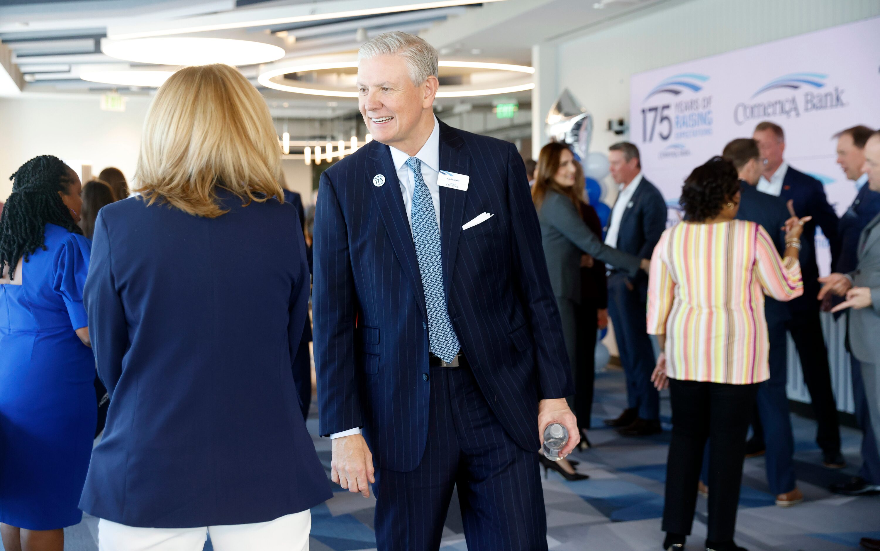 Comerica Chairman, President and Chief Executive Officer Curt Farmer (center) visits with...