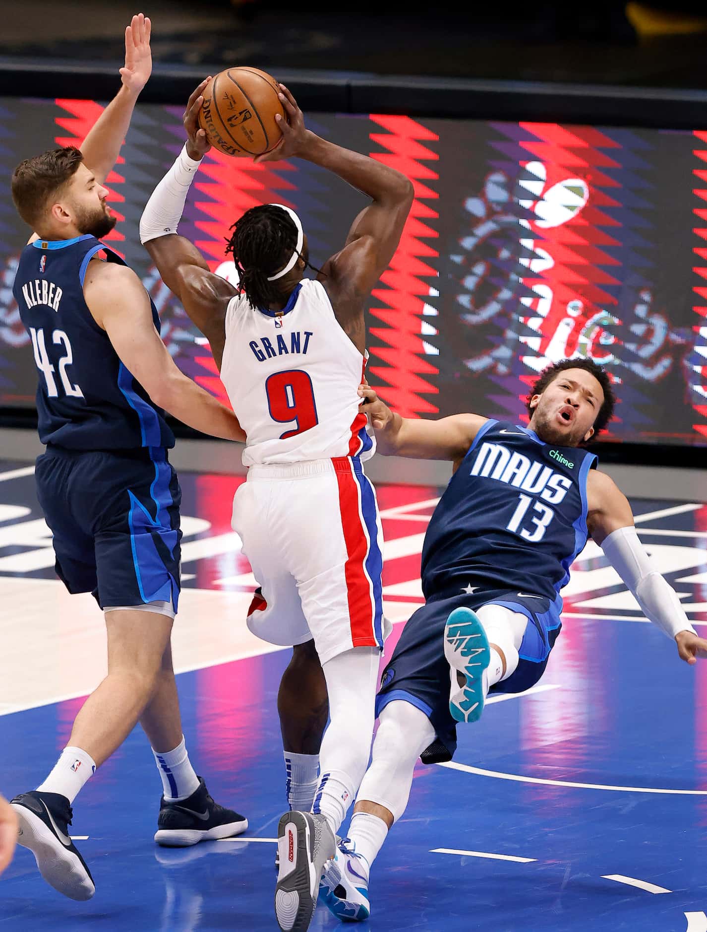 Dallas Mavericks guard Jalen Brunson (13) takes a charge from Detroit Pistons forward Jerami...