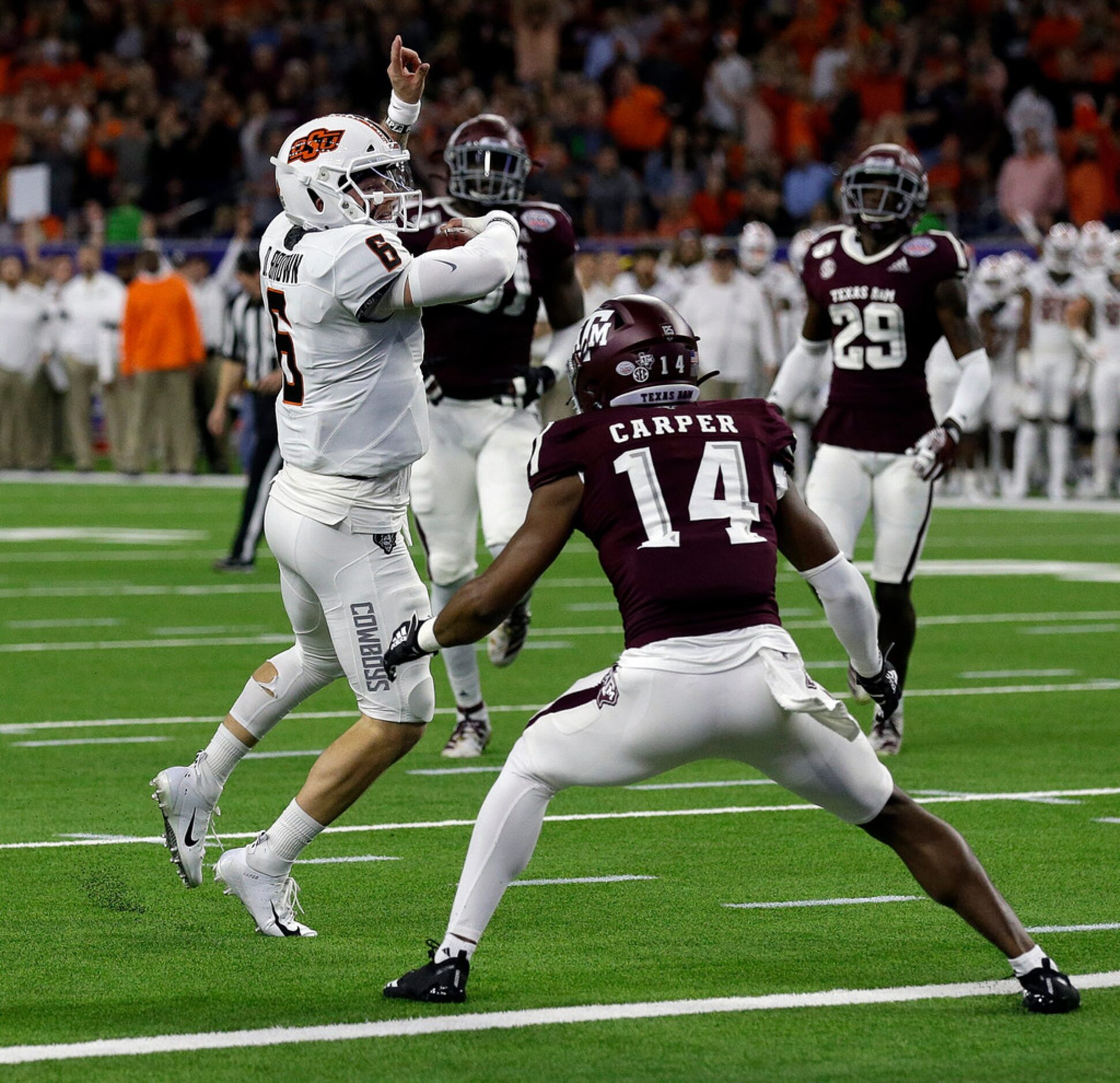 HOUSTON, TEXAS - DECEMBER 27: Dru Brown #6 of the Oklahoma State Cowboys scores on a nine...