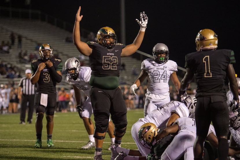 DeSoto junior offensive lineman Josh Jynes (52) signals for a touchdown against Denton Guyer...