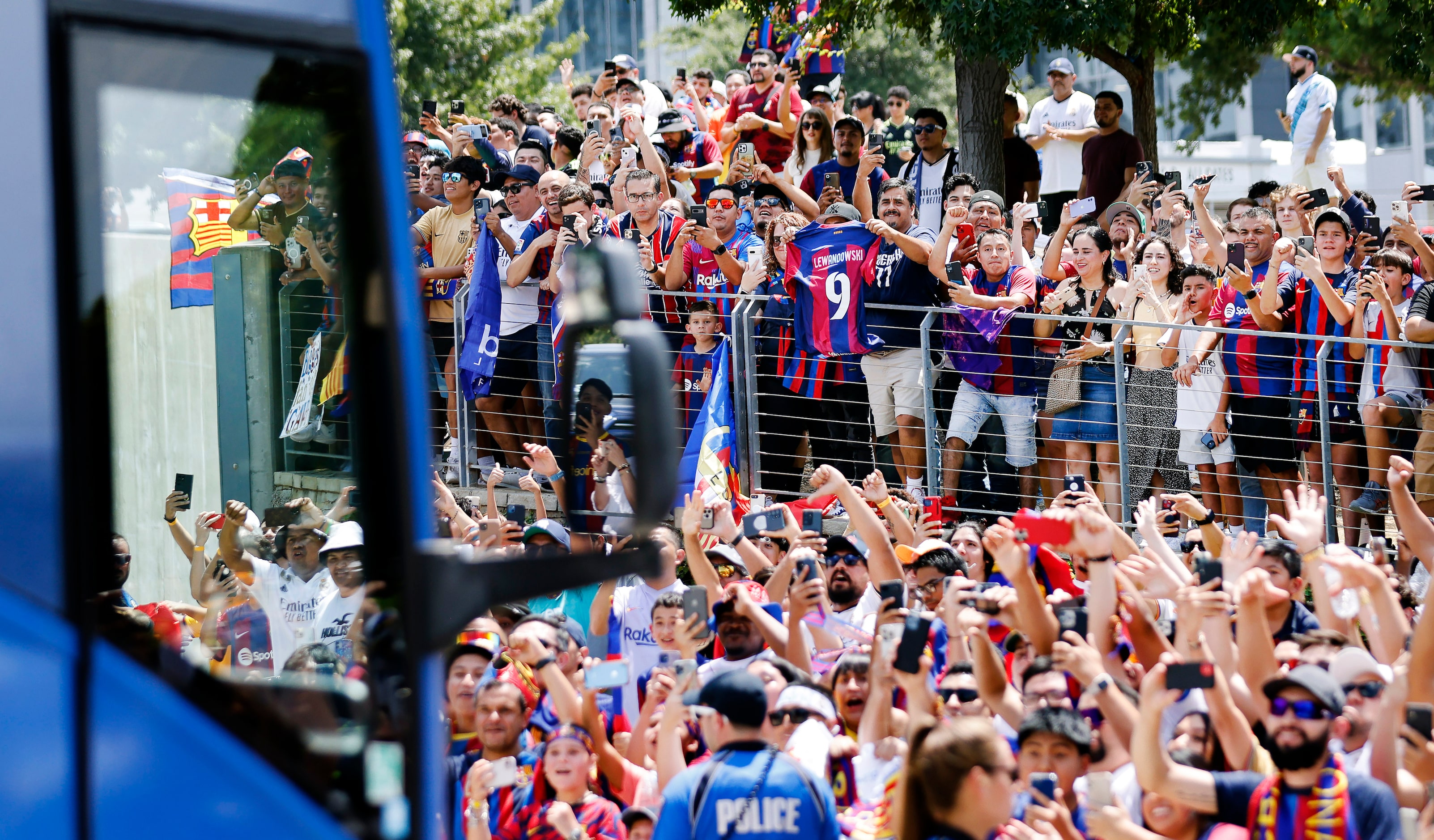 Barcelona soccer fans cheer as their team buses arrive for a Soccer Champions Tour futbol...