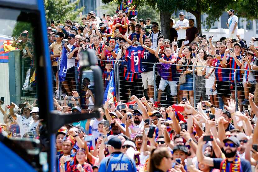Barcelona soccer fans cheer as their team buses arrive for a Soccer Champions Tour futbol...