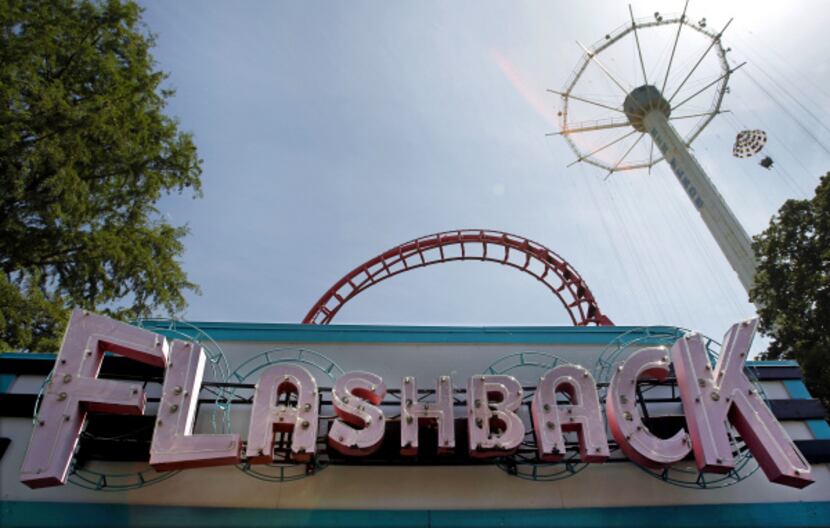 The sign for the Flashback ride (center) and the Texas Chute Out (top right) are pictured at...
