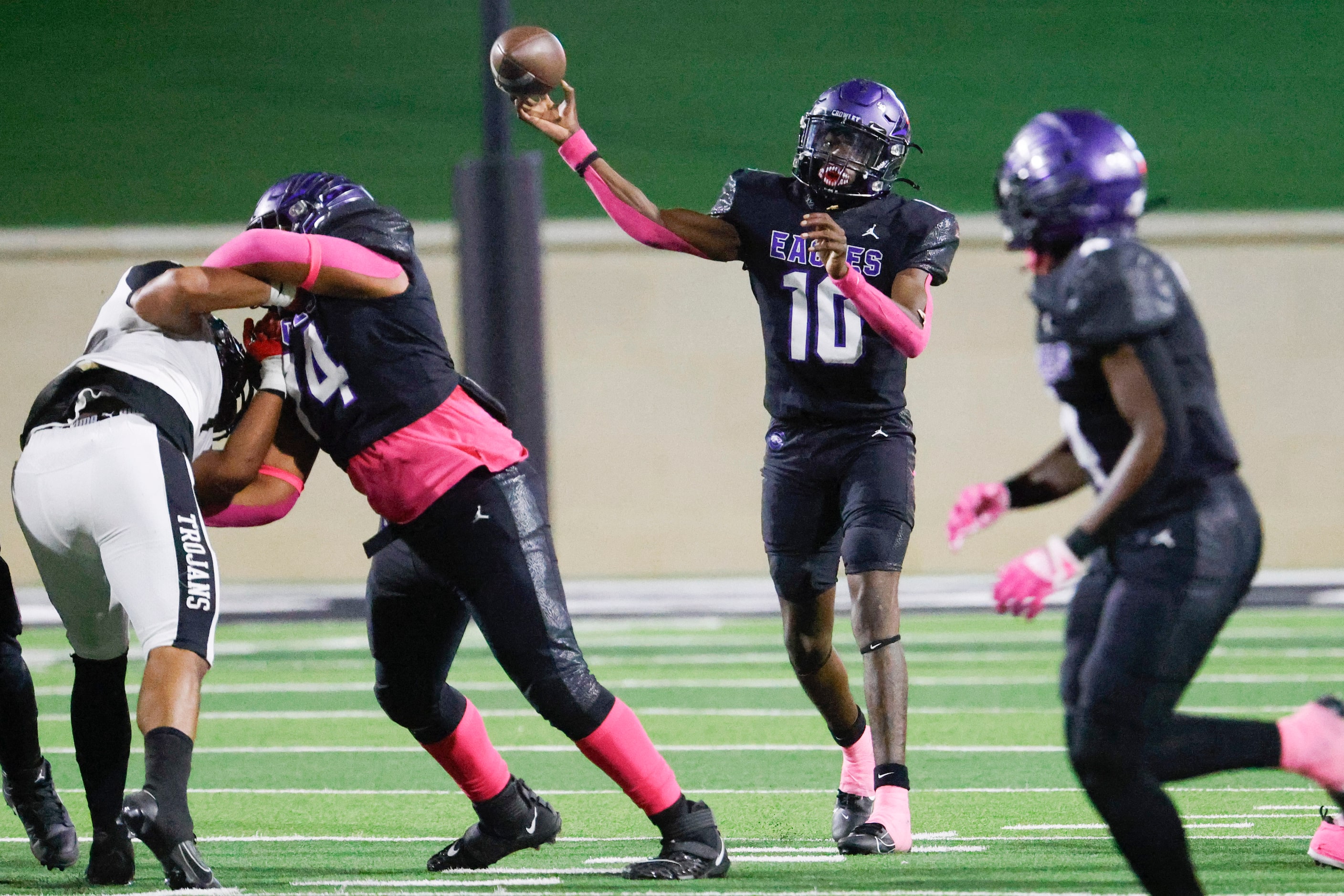 Crowley High’s Caleb Wiliams (10) throws the ball agistn Trinity High during the first half...