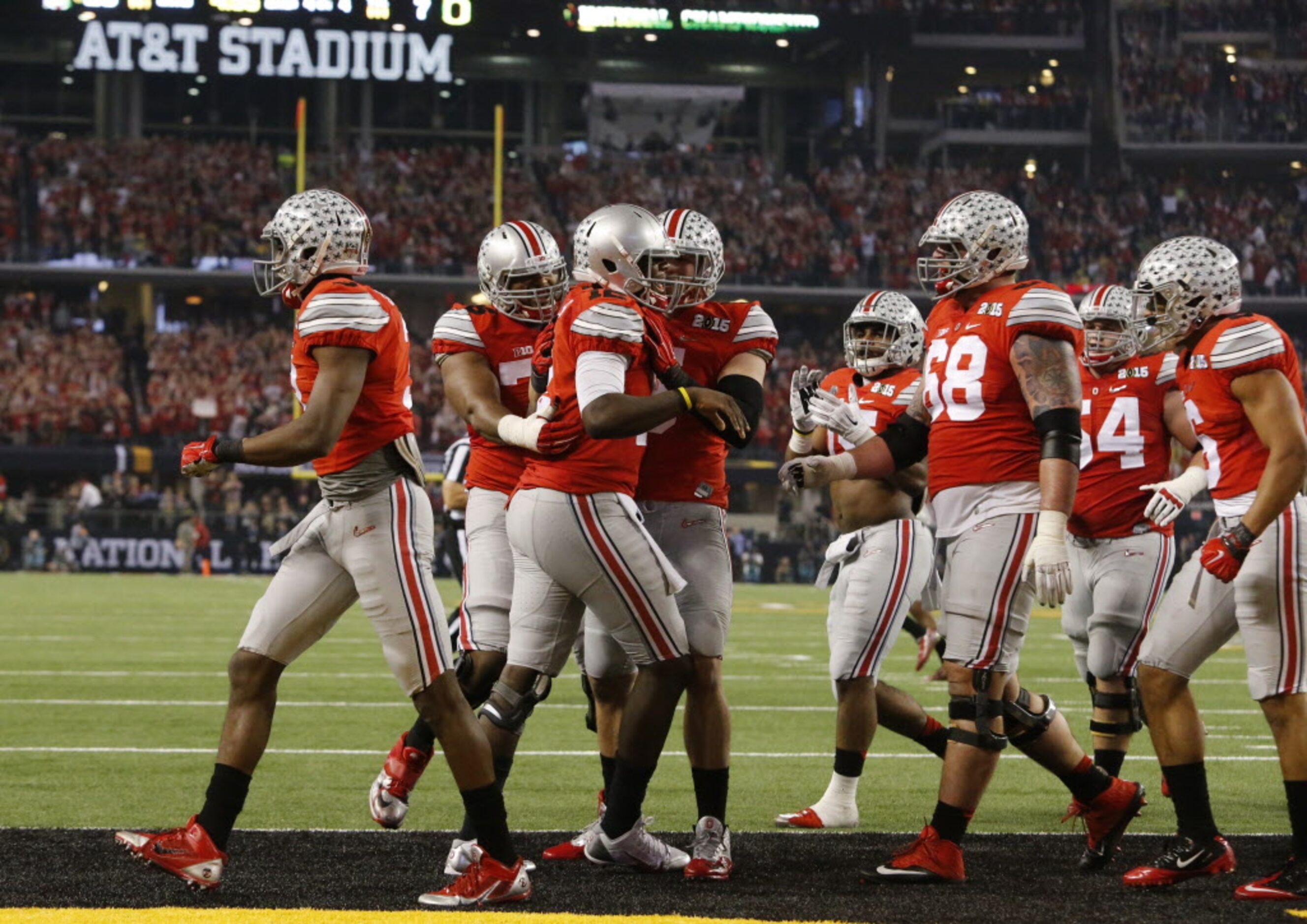 Ohio State Buckeyes quarterback Cardale Jones is congratulated by teammates after he score a...