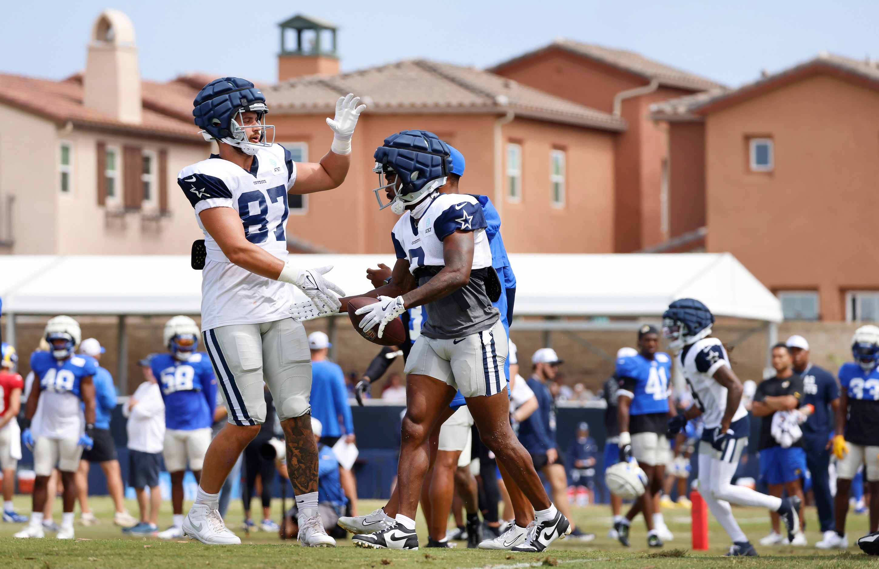 Dallas Cowboys tight end Jake Ferguson (87) congratulates wide receiver Brandin Cooks (3) on...