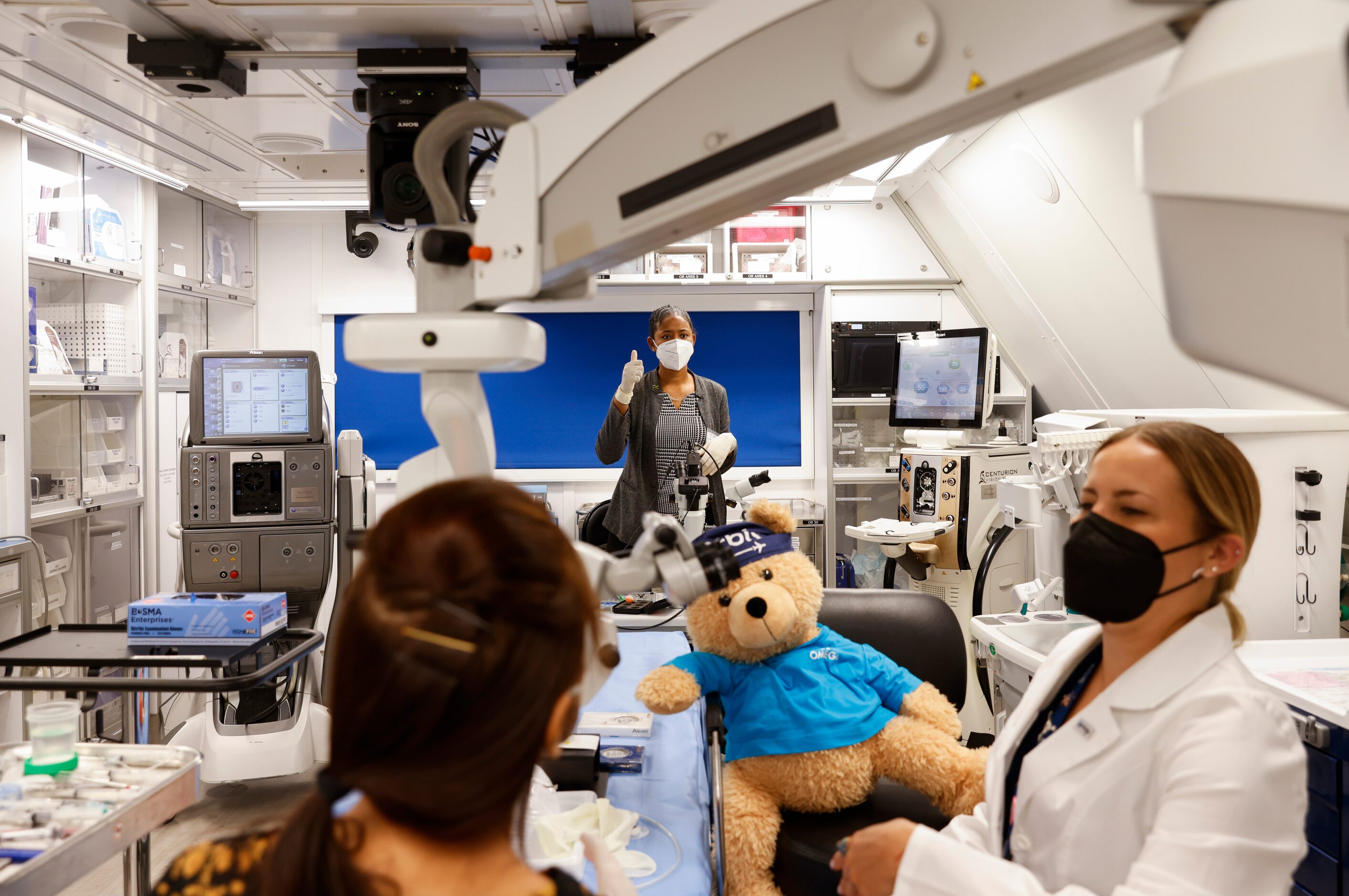 Orbis Flying Eye Hospital resident Dr. Kimberly Hastings of Jamaica, center, gestures...