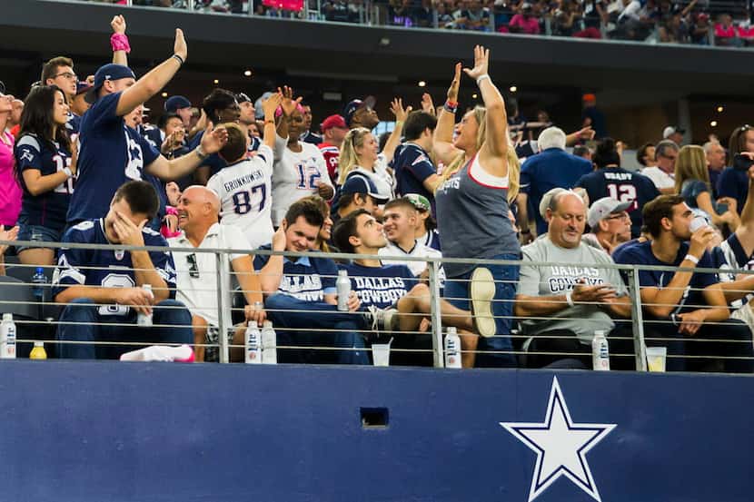 New England Patriots fans celebrate and Cowboys fans look disgusted after cornerback Logan...