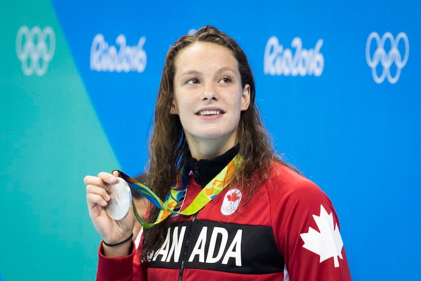 Penny Oleksiak of Canada shows off her silver medal from the women's 100m butterfly finals...