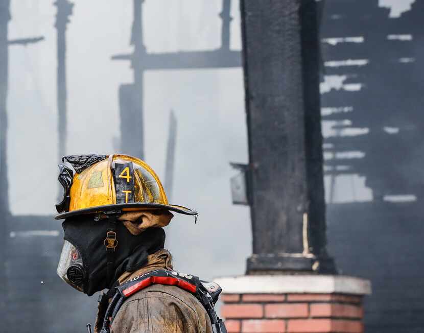 Dallas firefighters extinguish flames at a house in the 800 block of Centre Street.