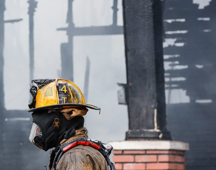 Dallas firefighters extinguish flames at a house in the 800 block of Centre Street.