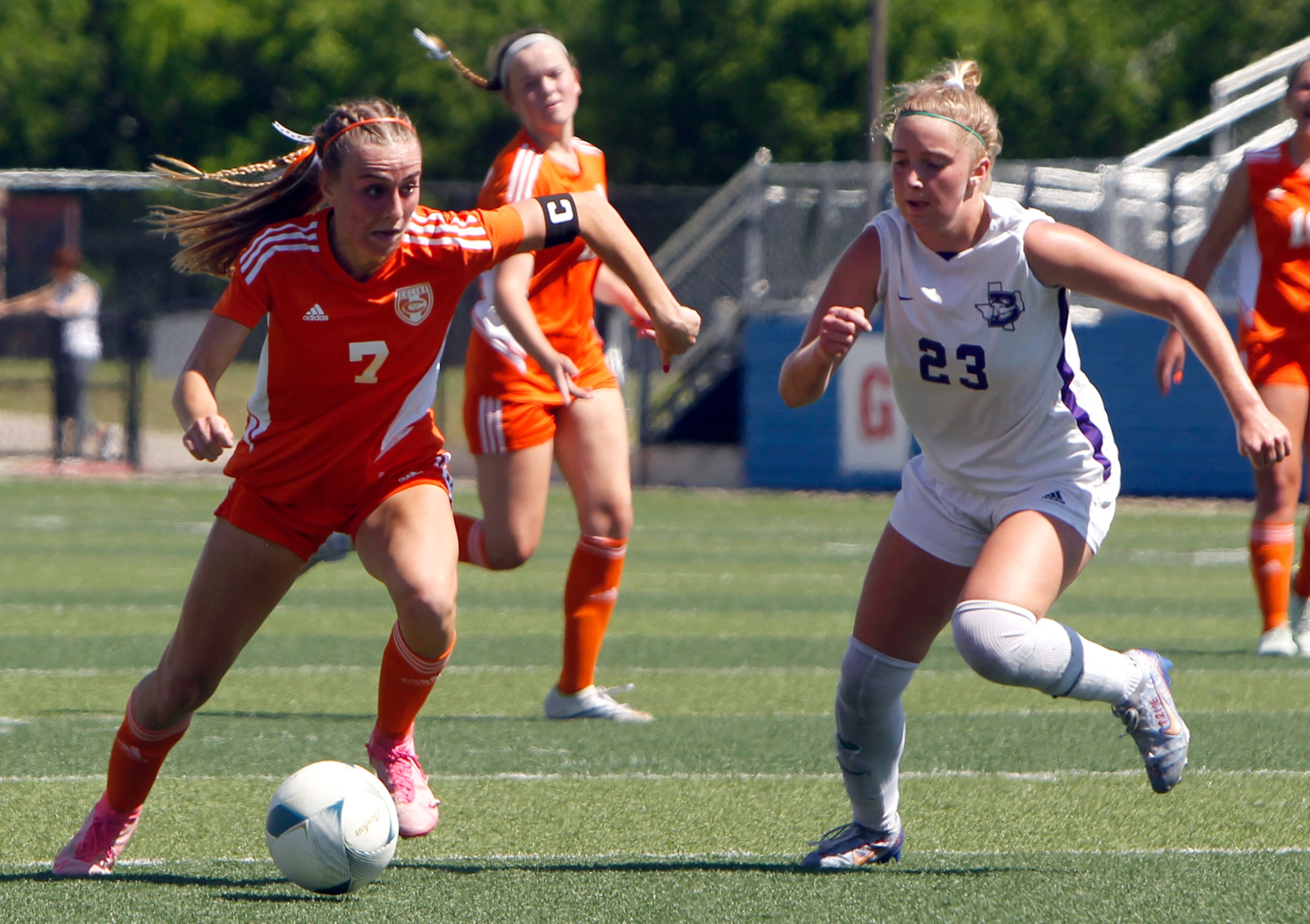 Celina's Lexi Tuite (7) eyes the goal as she scores over the defense of Boerne's Madeline...