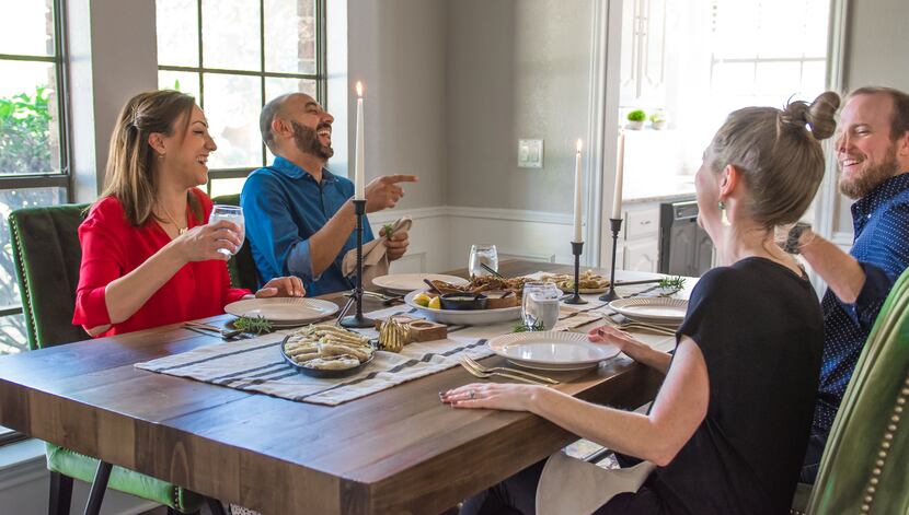 Tamara Abuomar and husband Feras Abumuwis eat a meal with writer and neighbor Rebecca White...