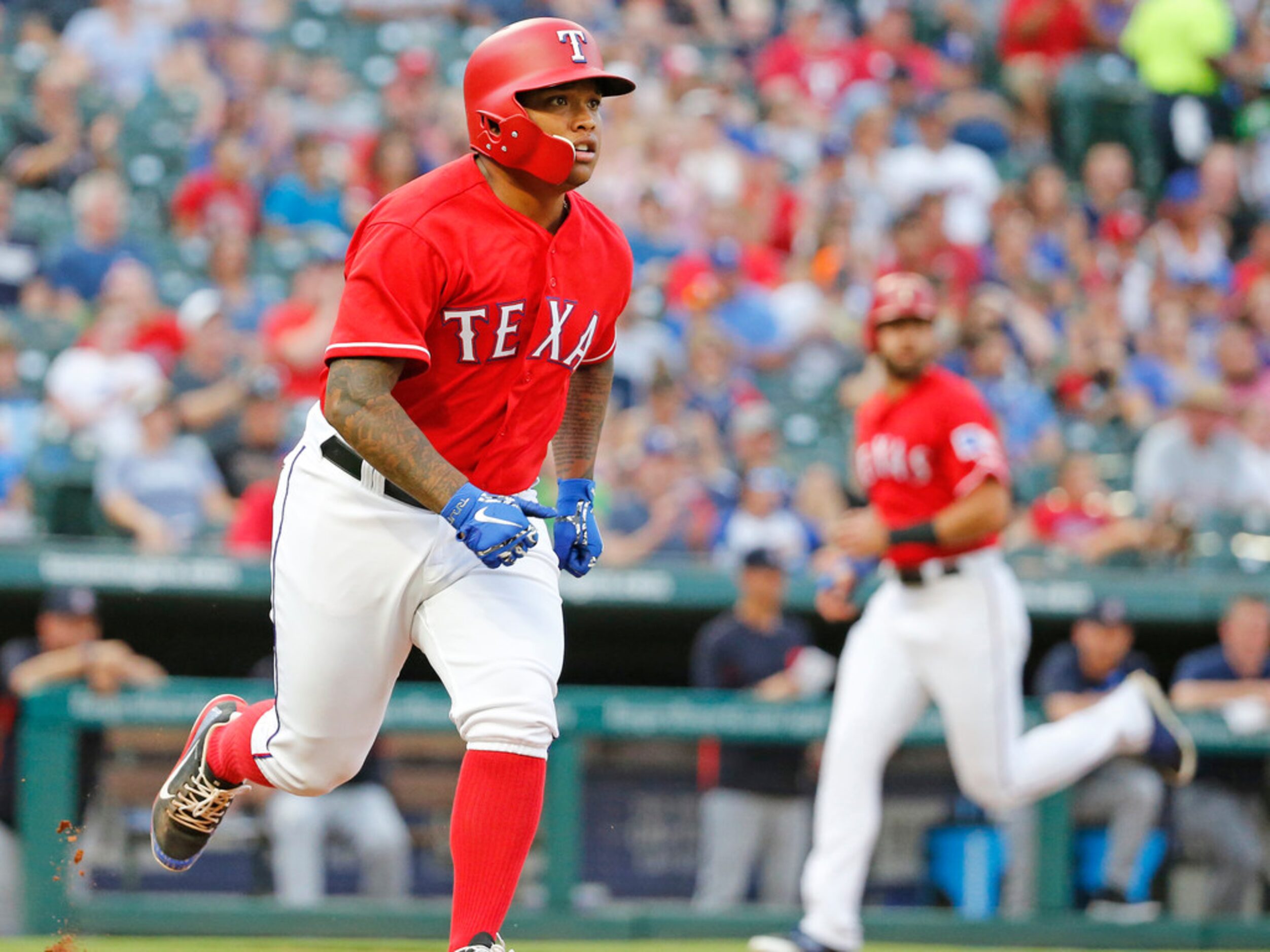 Texas Rangers designated hitter Willie Calhoun (5) singles in a run in the second inning...