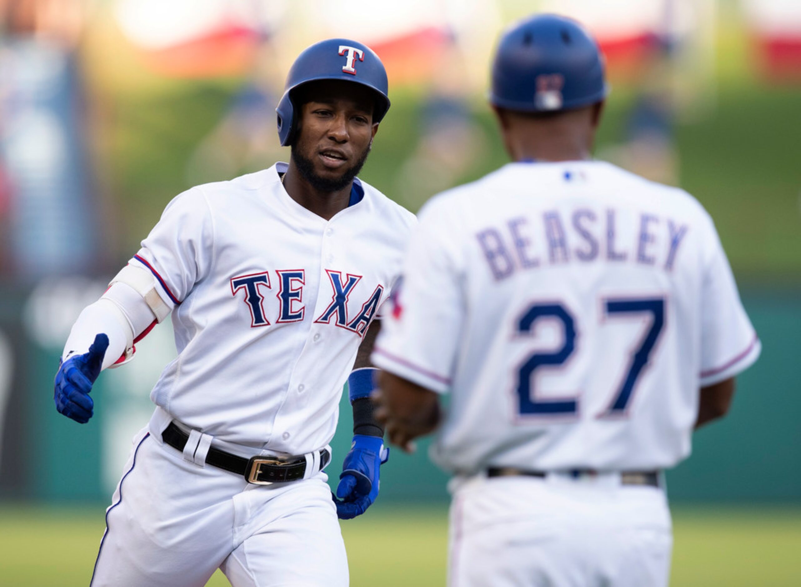 Texas Rangers' Jurickson Profar, left, is congratulated by third base coach Tony Beasley...