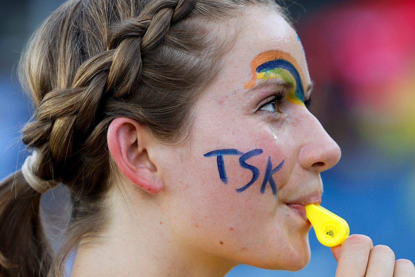 Gracen Flemming blows into a whistle while cheering ahead of the opening game of Major...