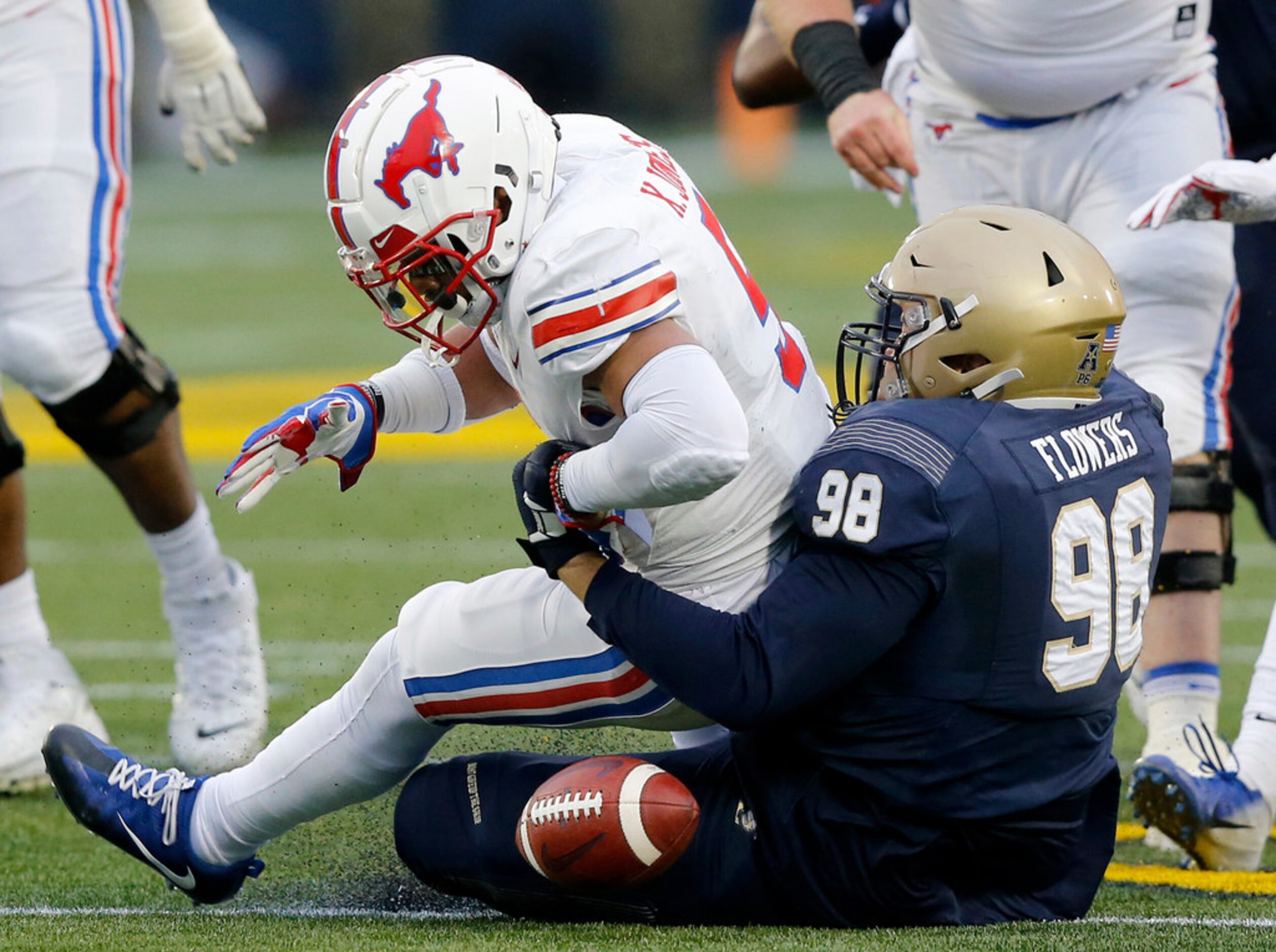 Navy Midshipmen defensive lineman Mike Flowers (98) forces Southern Methodist Mustangs...