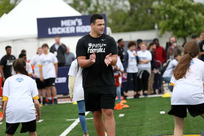 Lineman Connor Williams, an NFL draft prospect from University of Texas, leads a drill with...