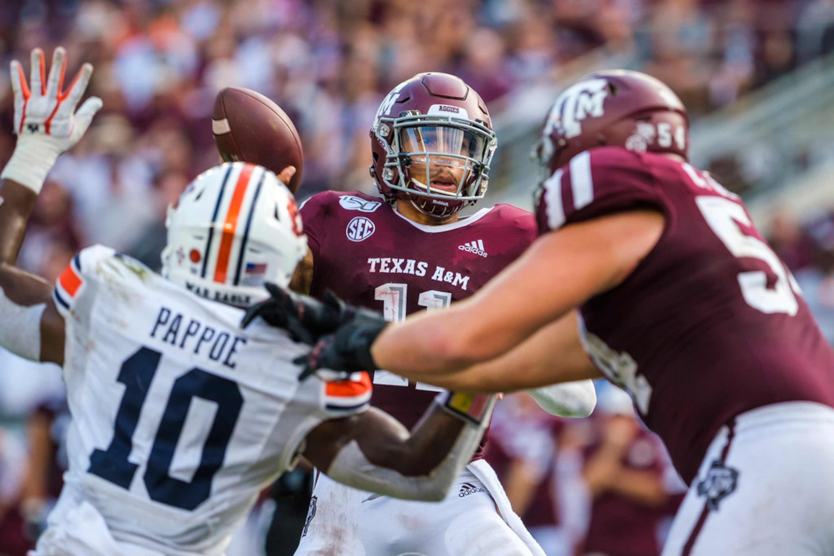 Texas A&M quarterback Kellen Mond (11) throws a pass as he gets a block from offensive...