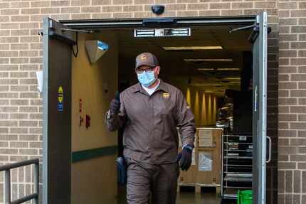 UPS driver Paul Pieroni, 55, gives a thumbs-up after delivering a shipment of the Pfizer...