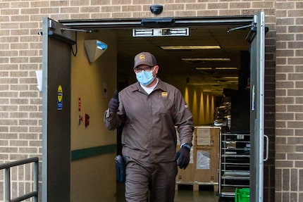 UPS driver Paul Pieroni, 55, gives a thumbs-up after delivering a shipment of the Pfizer...