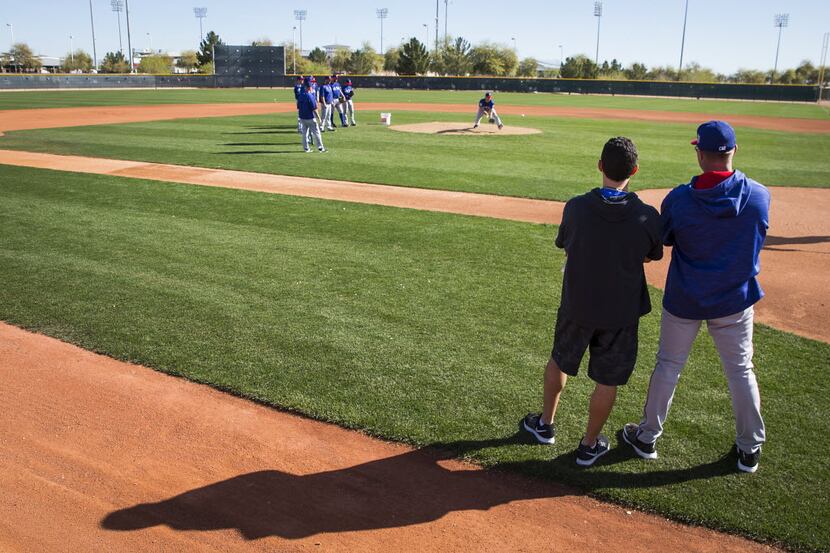 Texas Rangers General Manager Jon Daniels (left) and manager Jeff Banister watch pitchers...