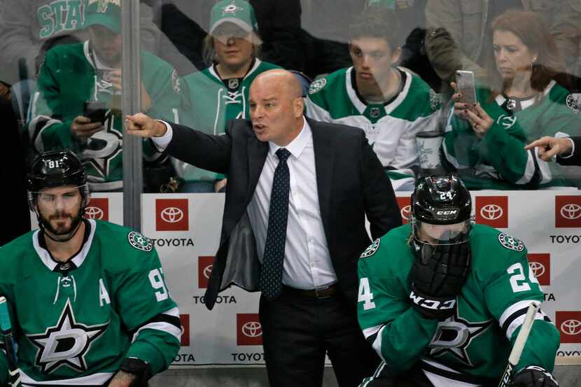 Dallas Stars head coach Jim Montgomery makes a point to his players late in the third period...