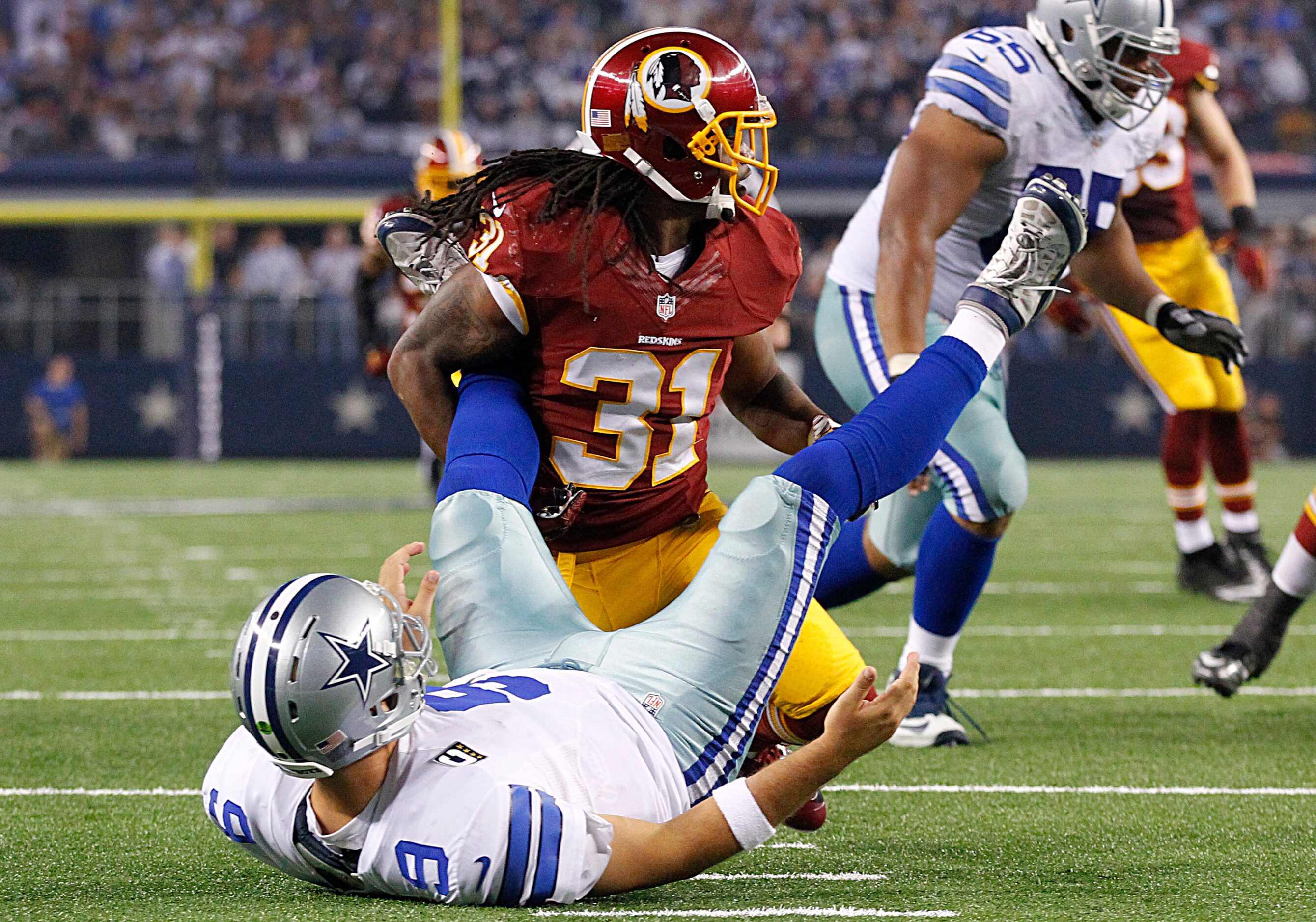 Washington Redskins strong safety Brandon Meriweather (31) sacks Dallas Cowboys quarterback...