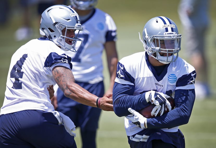 Cowboys rookie running back Darius Jackson (right) gets the ball from rookie quarterback Dak...