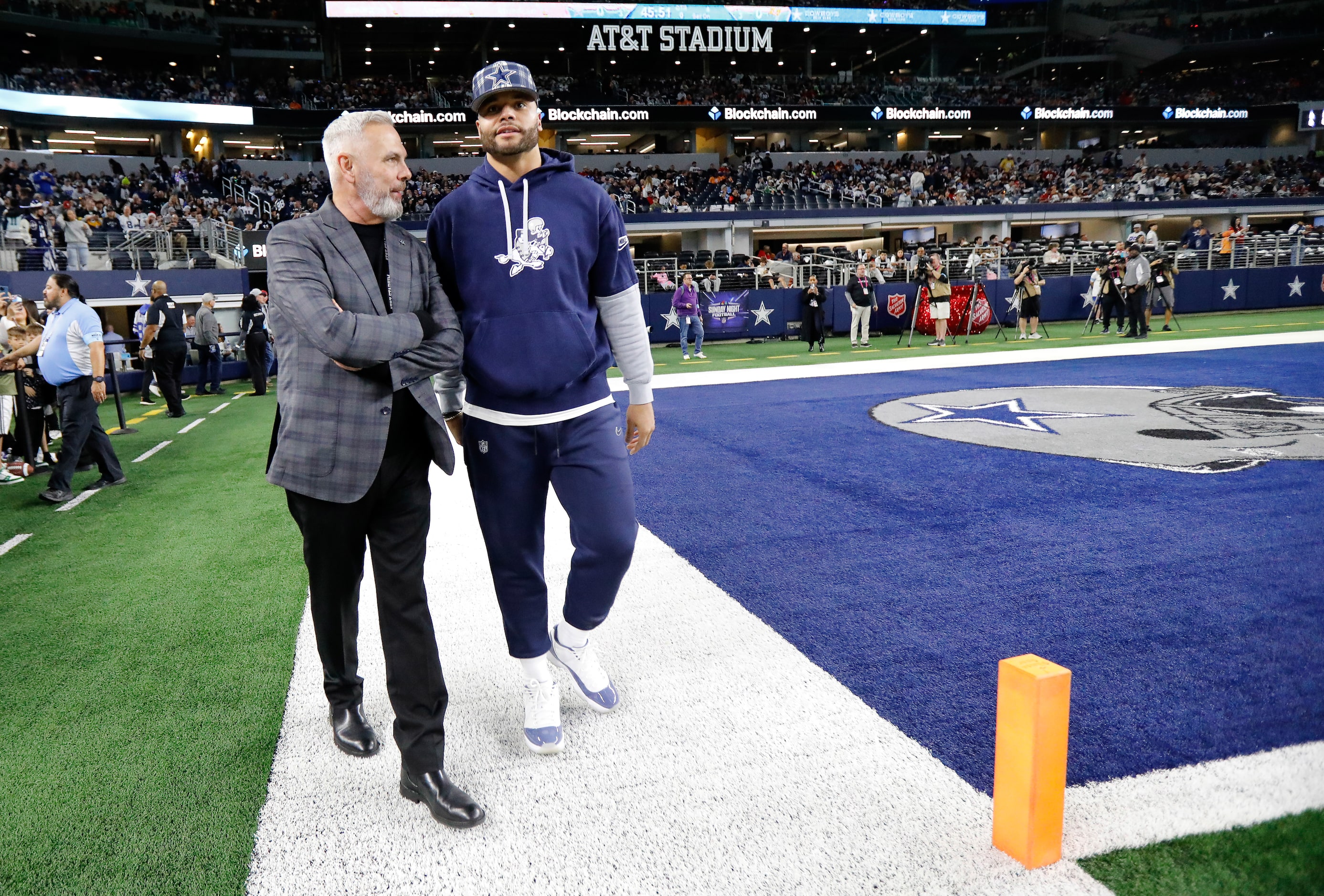 Injured Dallas Cowboys quarterback Dak Prescott (right) walks without a leg brace and...