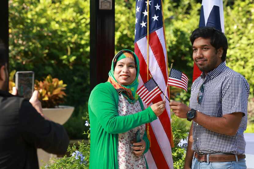 Tanjima Akhtar y su hijo, Seean Hossain, sostienen una bandera estadounidense en su...
