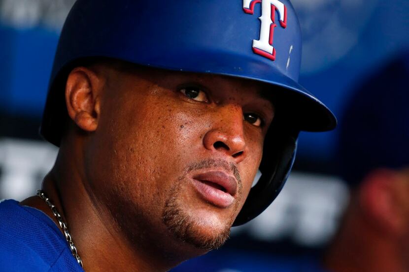 Texas Rangers third baseman Adrian Beltre dons a helmet as he prepares to bat against the...