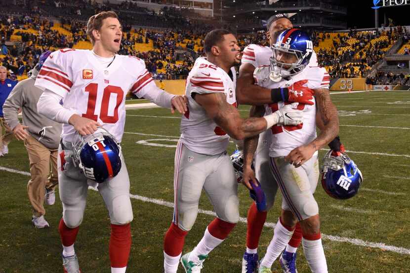 New York Giants wide receiver Odell Beckham (13) is restrained by teammates from going after...