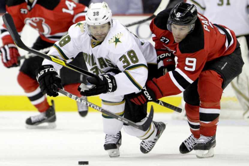 Dallas' Vernon Fiddler (38) competes for the puck with New Jersey's Zach Parise (9) during...