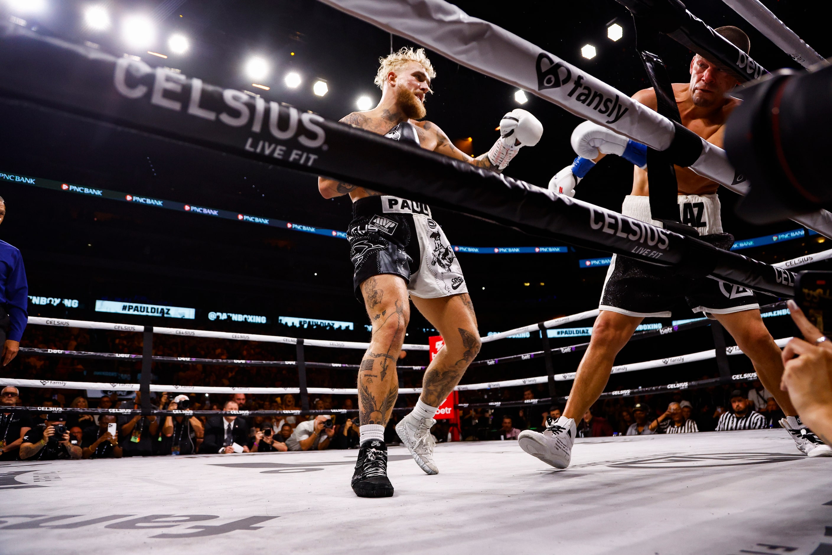 Jake Paul, left, lands a punch on Nate Diaz during a boxing match in Dallas, Saturday,...