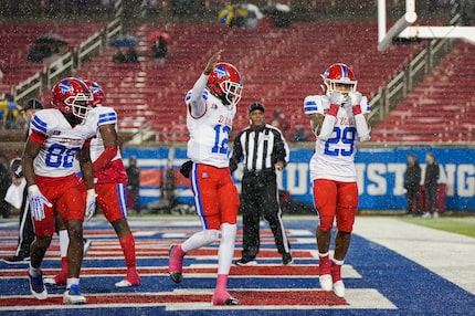 Duncanville running back Caden Durham (29) celebrates with quarterback Keelon Russell (12)...