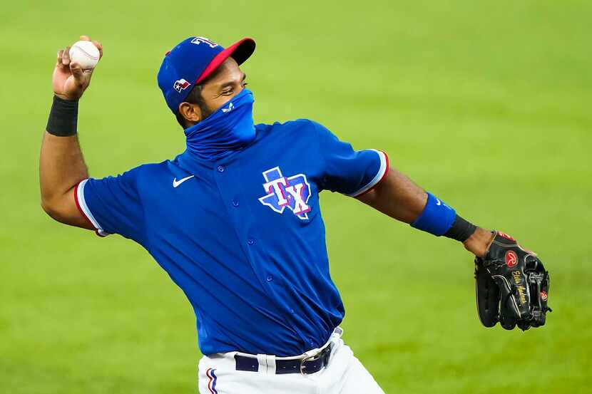 Texas Rangers shortstop Elvis Andrus donned a face mask while warming up before an...