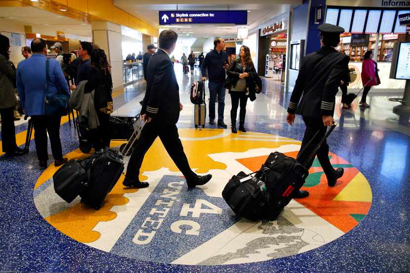 American Airlines pilots and passengers traverse the new, quieter Terrazzo flooring which...