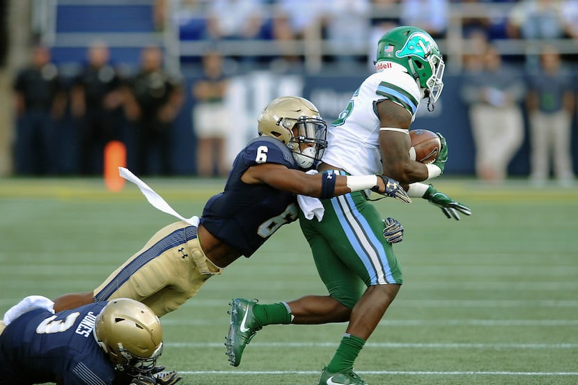 Navy safety Sean Williams tackles Tulane's running back Dontrell Hilliard on a run in the...