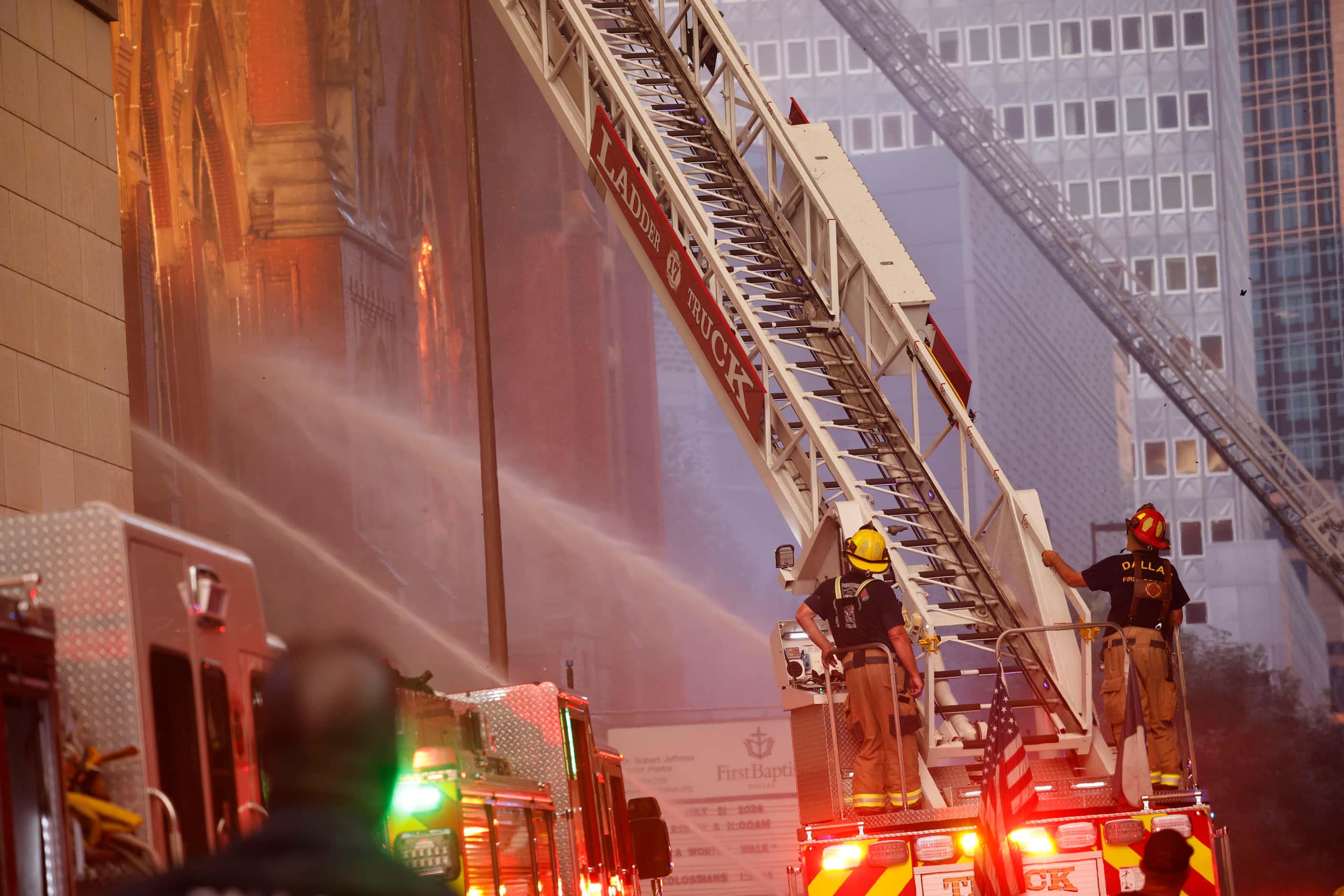 Firefighters work at the scene of a fire at First Baptist Dallas church on Friday, July 19,...