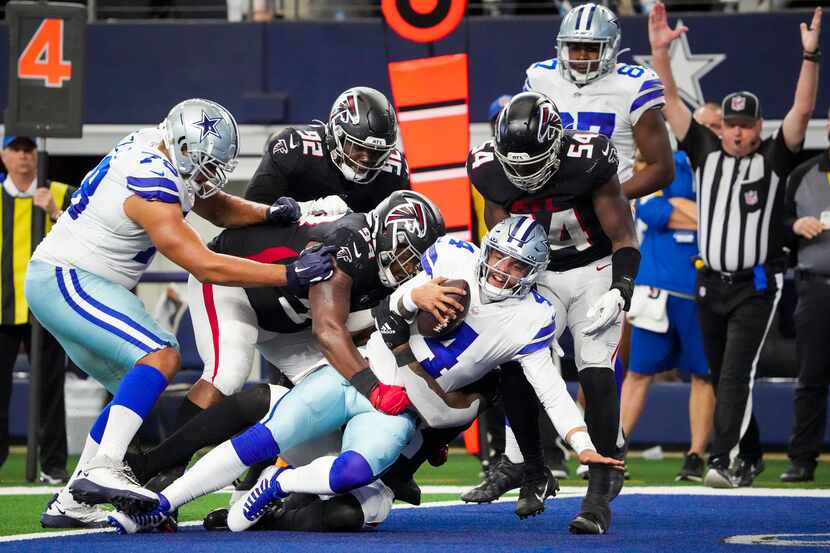 Dallas Cowboys quarterback Dak Prescott (4) pushes into the end zone to score on a four-yard...