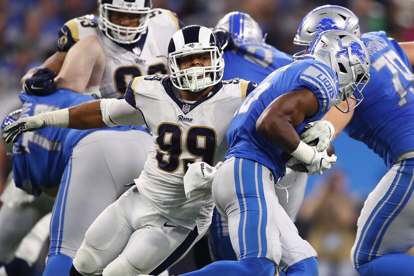 DETROIT, MI - DECEMBER 02: Aaron Donald #99 of the Los Angeles Rams tackles running back...