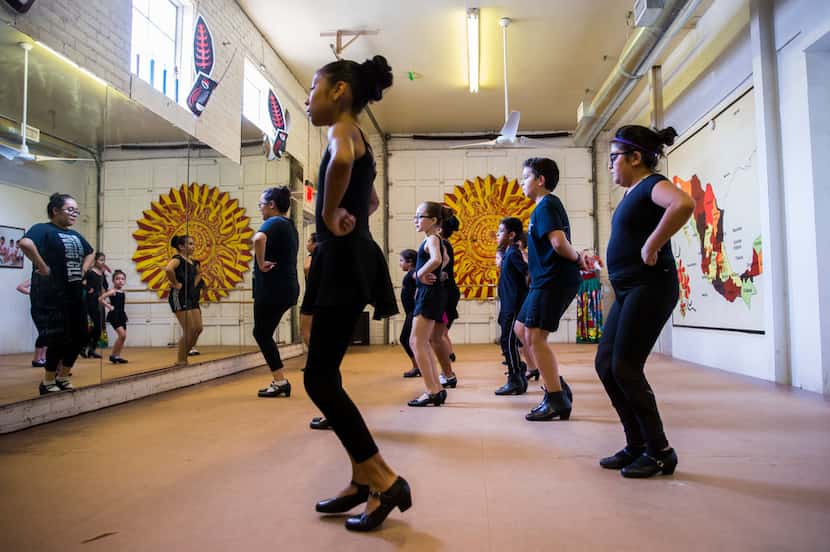Young dancers warm up during dance company auditions at the Anita N. Martinez Ballet...