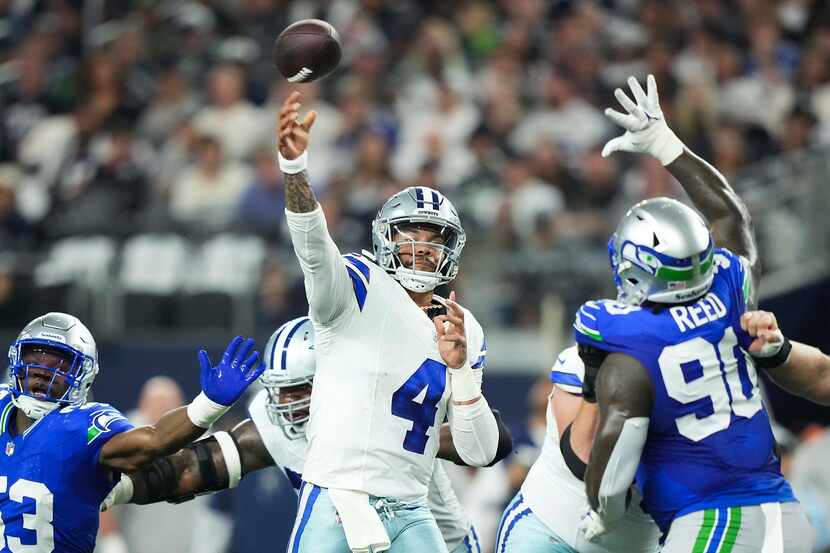 Dallas Cowboys quarterback Dak Prescott (4) throws a touchdown pass over Seattle Seahawks...